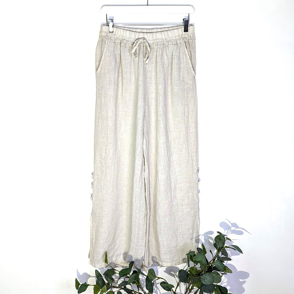 Straight leg linen trousers with small slit and button detail on the side (M)