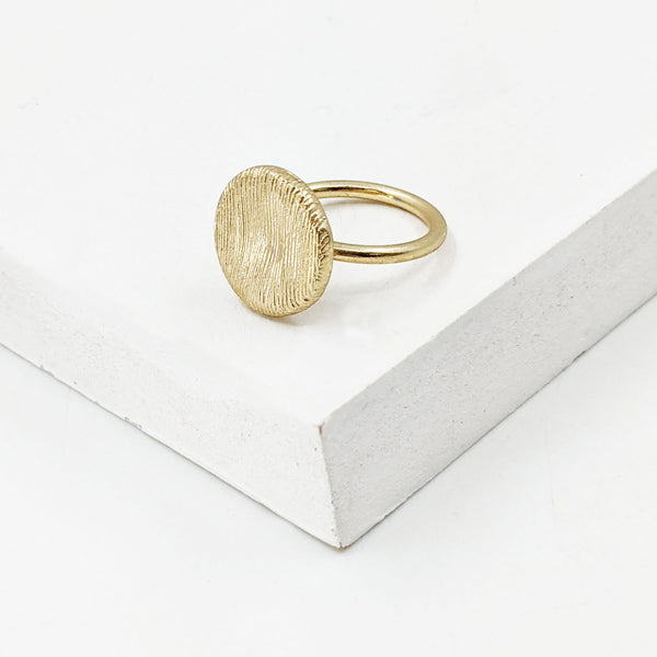 Delicate designer style scratch finish disc ring