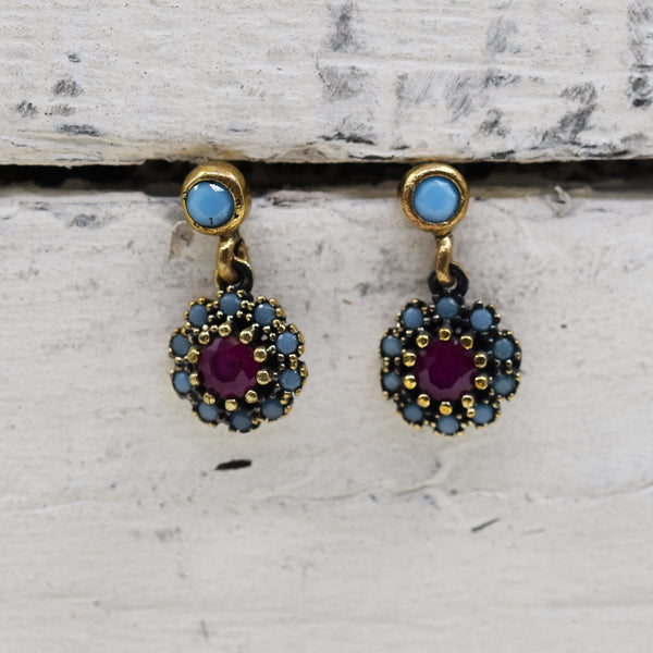 Flower shape stud earrings with purple stone centre