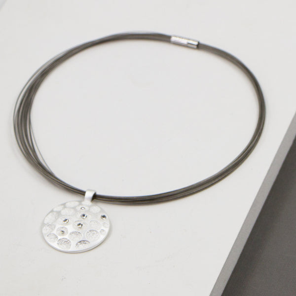 Dimpled circle with diamantes on short multi-cable necklace