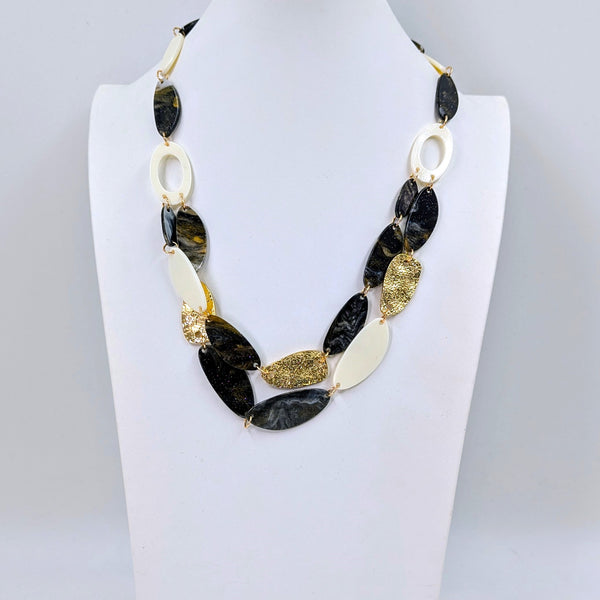 Organic resin shapes with metal components and 2 strand section necklace