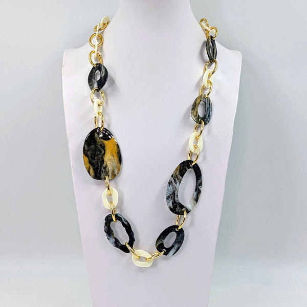 Substantial long organic resin shapes and golden links necklace
