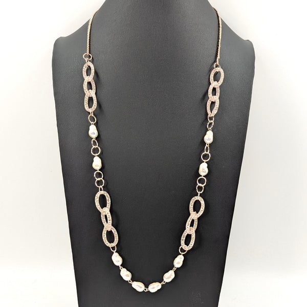 Long necklace with crystal encased links and faux pearl sections