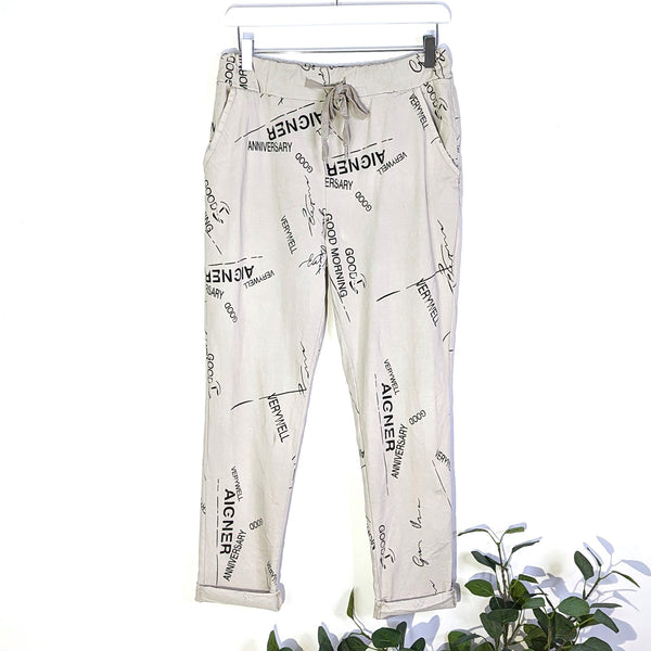 Super stretch trousers with random writing