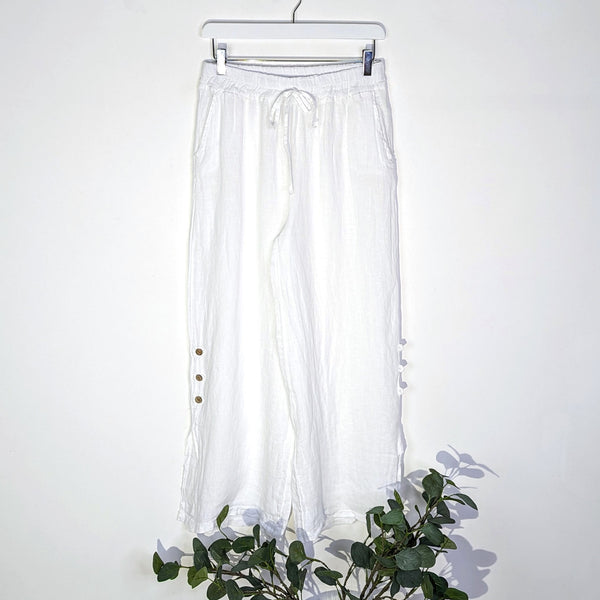Straight leg linen trousers with small slit and button detail on the side