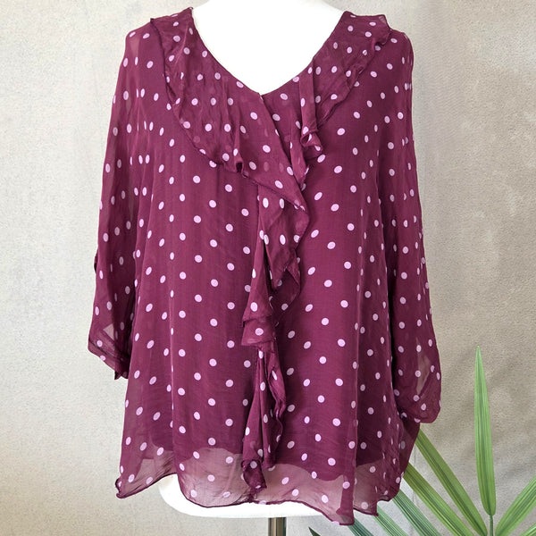Silk spotted top with frilled V neckline and fluted sleeves