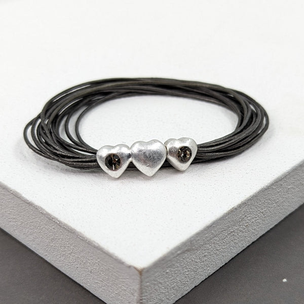 Multi strand leather bracelet with three hearts and diamante