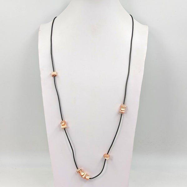 Multi shape beaten effect nuggets on long leather necklace
