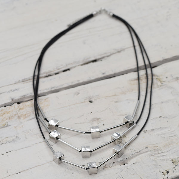 Black multistrand necklace with silver cubes and tubes