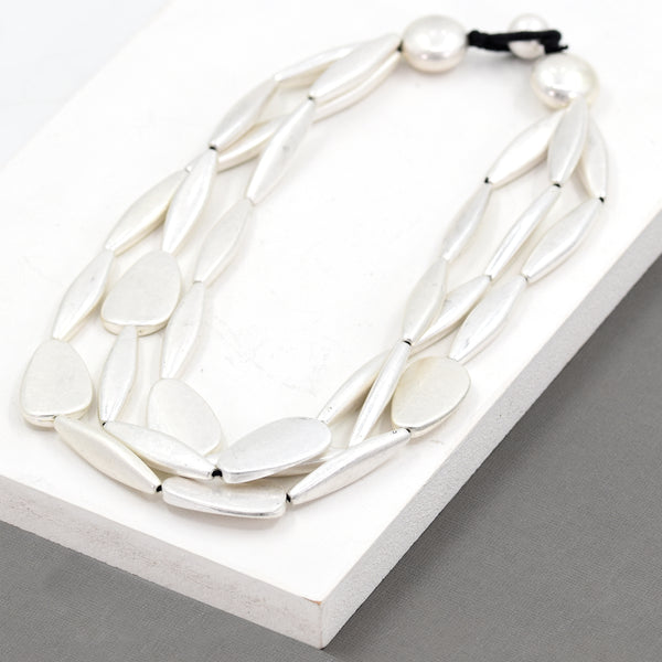 Multi-strand worn silver beaded statement necklace