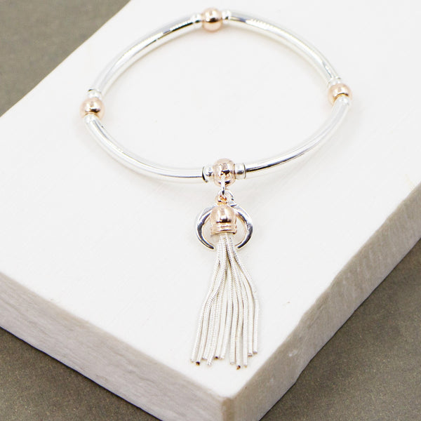 Stretchy tube bracelet with tassel and crescent moon component