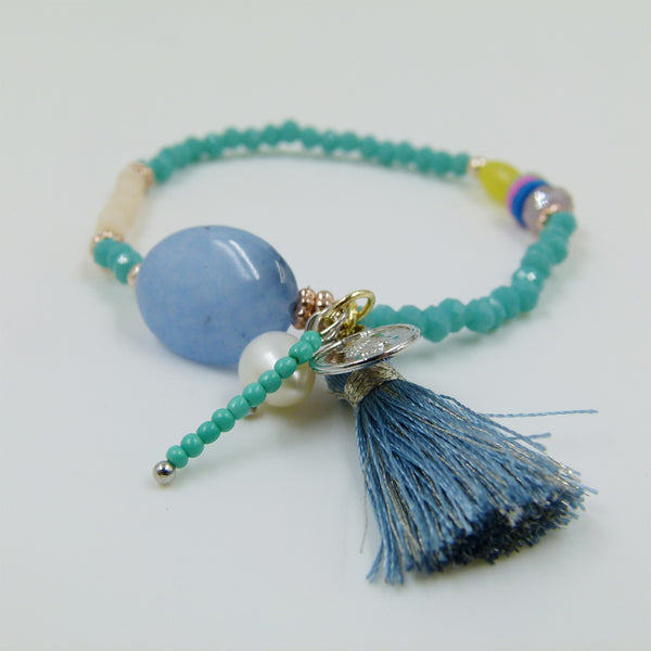 Beaded bracelet with tassle and coin charm