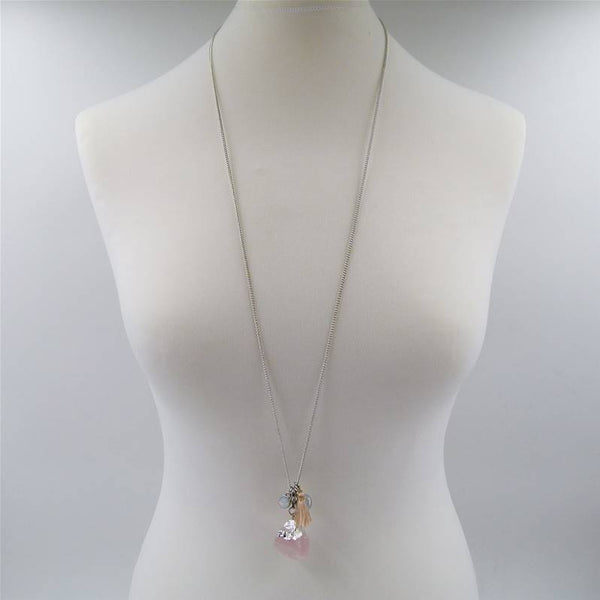 Quartz pendant on long necklace with multiple charms