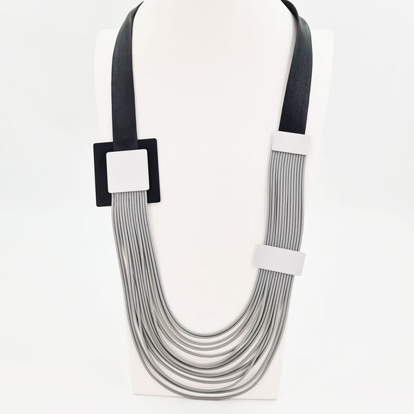 Fine multi strand neoprene mid length necklace with square elements