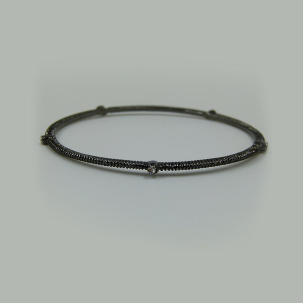 Delicate bangle w-5 interspaced set stones