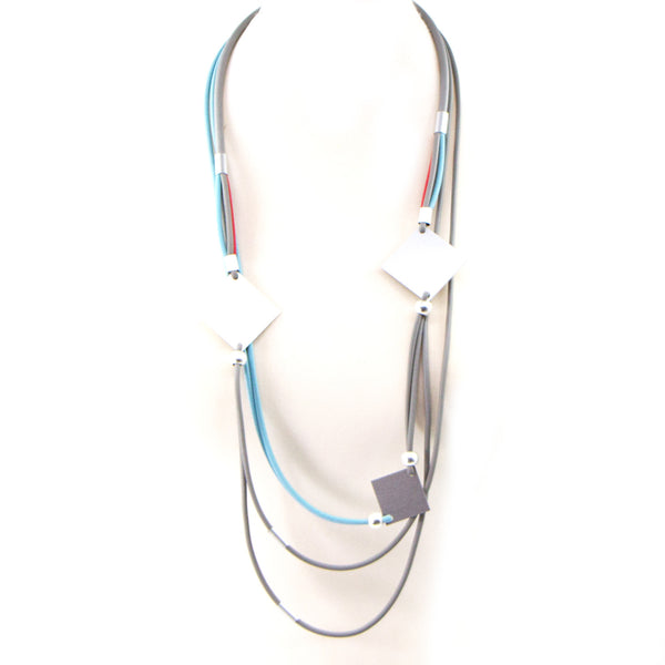 Long multistrand neoprene necklace with square components and tubes