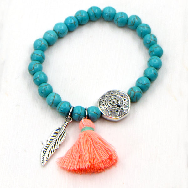 Stretchy beaded bracelet with tassle and feather charm