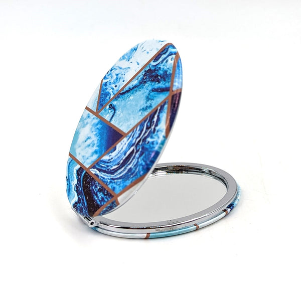 Angles and swirls oval compact mirror