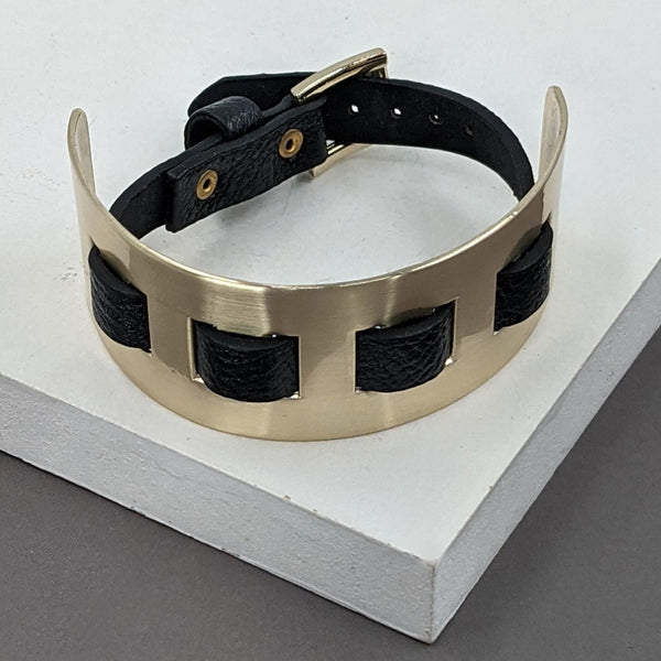Matt gold plated cuff with buckle interwoven with leather
