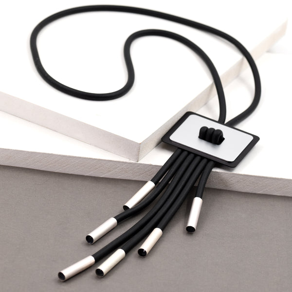 Long necklace with square pendant and tassel like feature