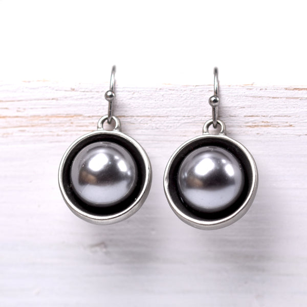 Pearl drop earrings encased in a metal surround