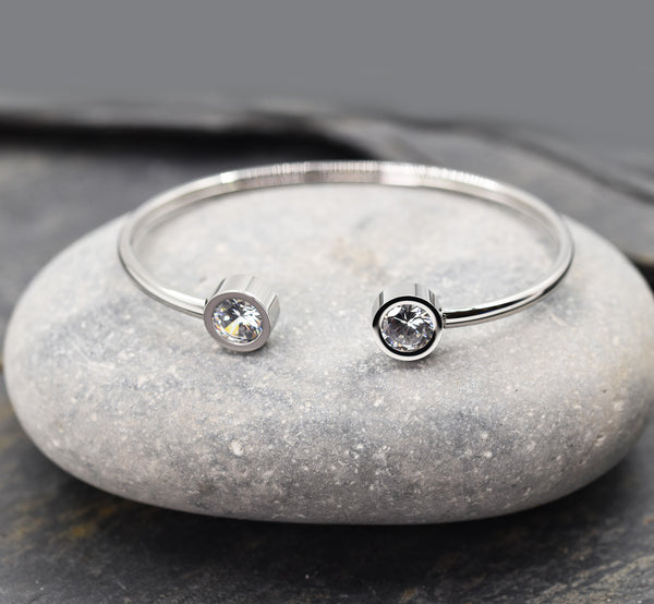 Sleek stainless steel memory style bangle with crystal ends