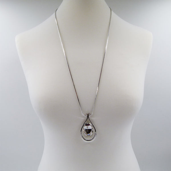 Encased crystal pendant on long chain