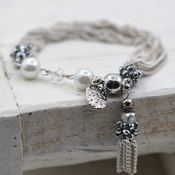 Multi strand and bead bracelet with tassel