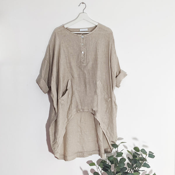 Roomy high-low linen top with front pockets and mother of pearl buttons