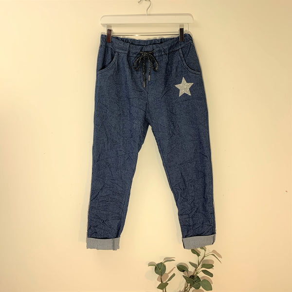 Stretchy jeans style trousers with silver star motif on pocket