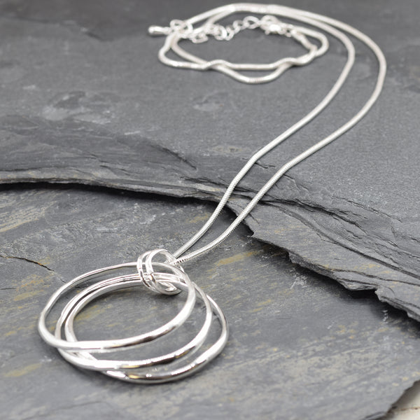 Layered circle pendants on long snake chain necklace