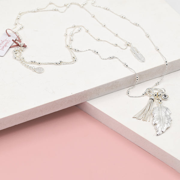 Feather and tassel pendants on long ball chain