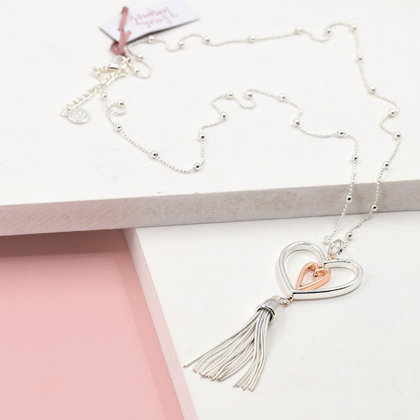 Double heart pendant with tassel feature on long ball chain