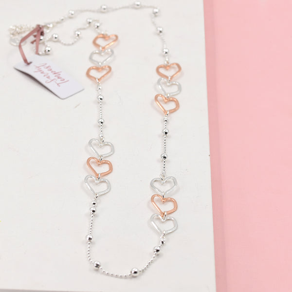 Long rope style necklace with mixed plated hearts