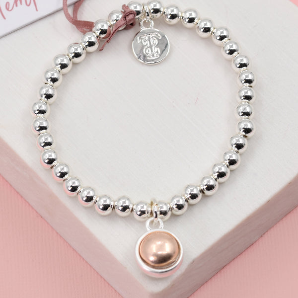 Orb shaped charm with rose gold inlay beaded stretchy
