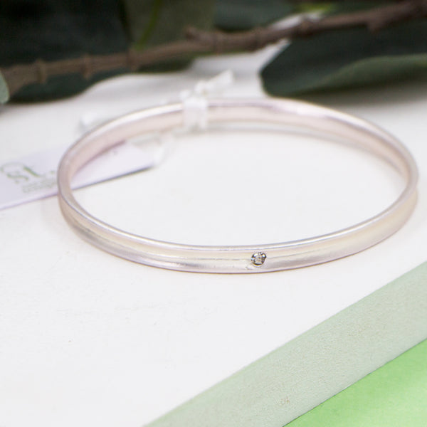 Matte silver bangle with crystal feature
