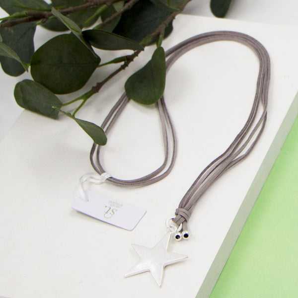 Star pendant on grey suede long necklace