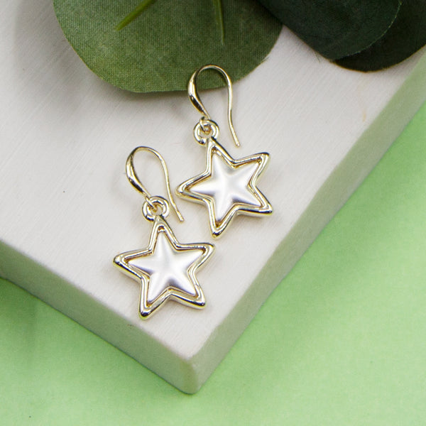 Gold fish hook star charm earrings with matte silver inlay