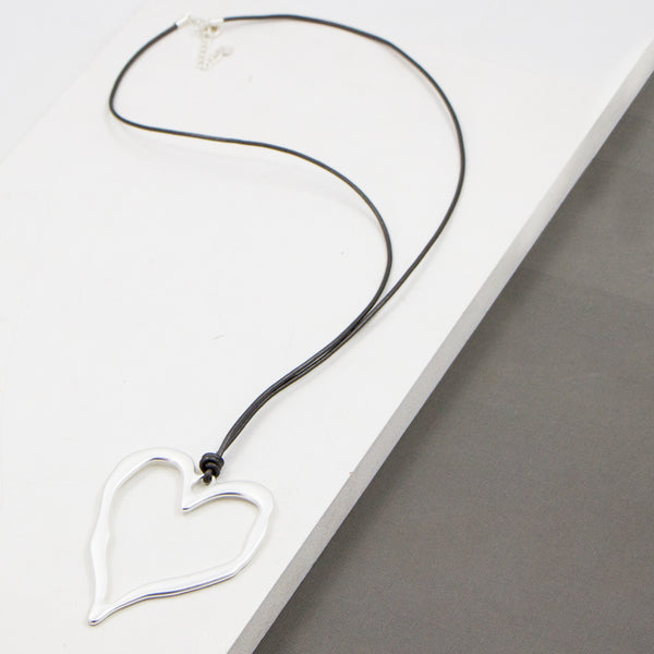 Beaten metal heart on simple long leather necklace