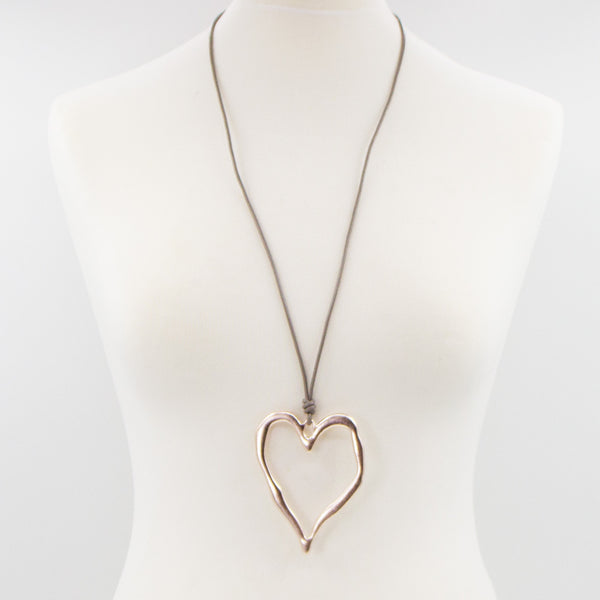 Beaten metal heart on simple long leather necklace
