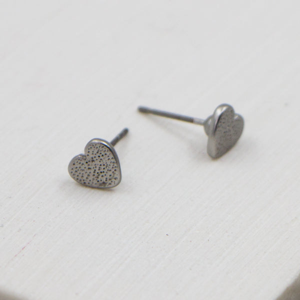 Tiny pitted effect heart stud earrings