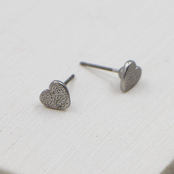 Tiny pitted effect heart stud earrings