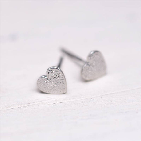 Tiny pitted effect heart stud earrings
