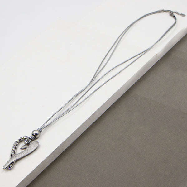 Scratched metal heart pendant on long leather necklace