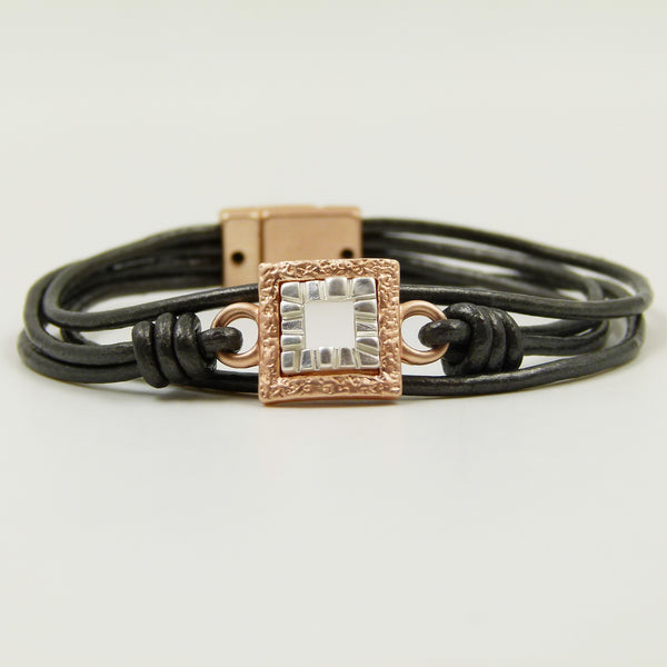Contemporary cutout square pendant on multi leather bracelet