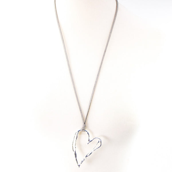 Irregular cutout heart pendant on long suede necklace