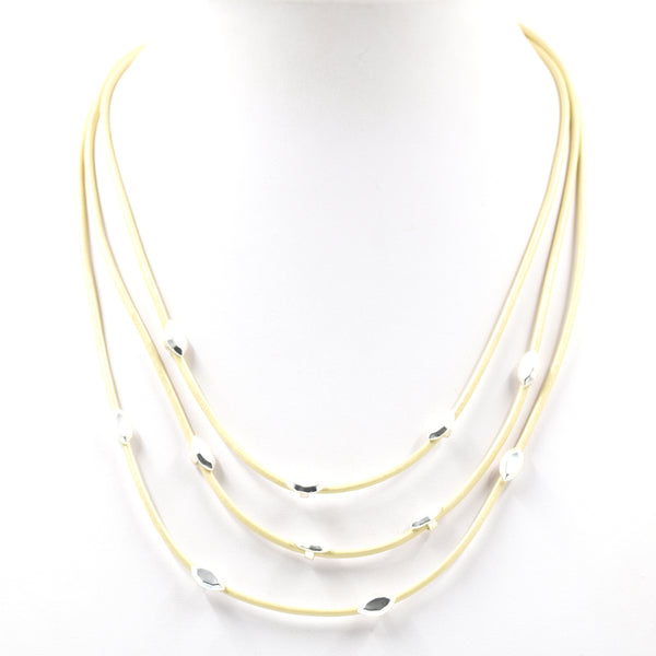 Solid & cutout silver details on multi-cord white necklace