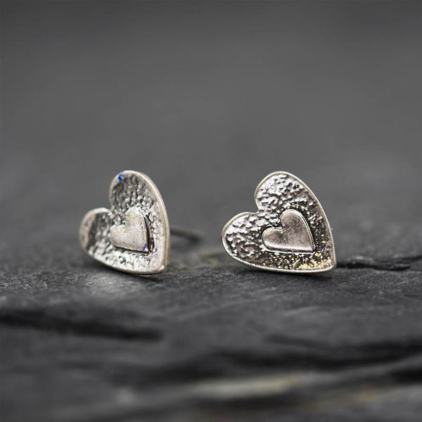 Dainty antique silver earrings in a heart relief design