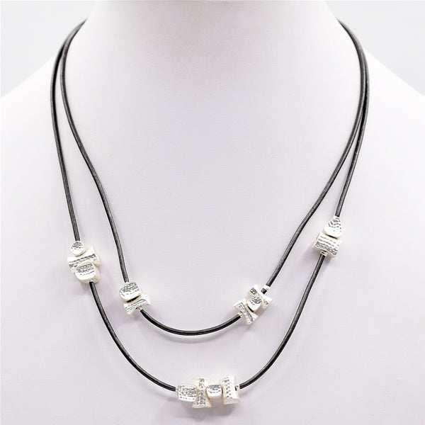 Multi shape beaten effect nuggets on short leather necklace