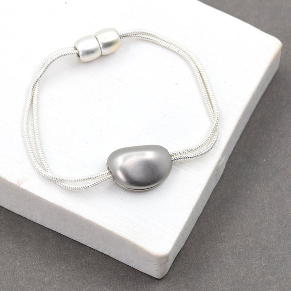 Double strand bracelet with pebble pendant